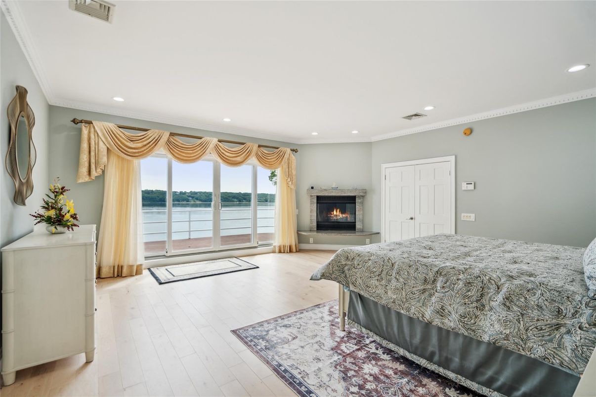 Bedroom, Fireplace, Interior, Recessed Lighting, Water, Wood Texture Flooring