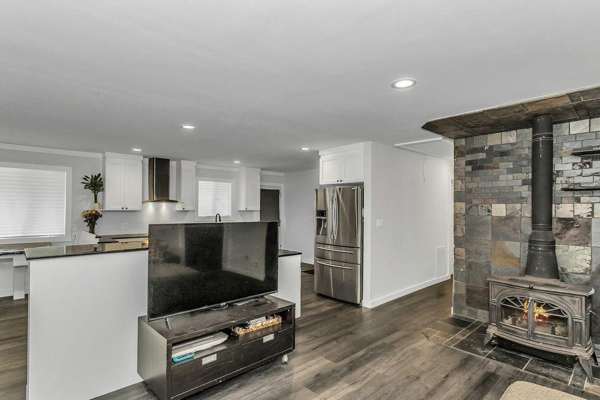 Fireplace, Interior, Kitchen, Recessed Lighting, Stainless Steel Appliances, Stone Walls, Wood Texture Flooring