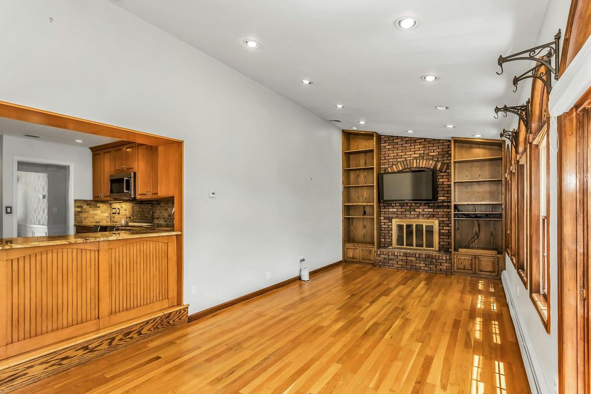 Empty room, Fireplace, Interior, Kitchen, Recessed Lighting, Stone Walls, Wood Texture Flooring