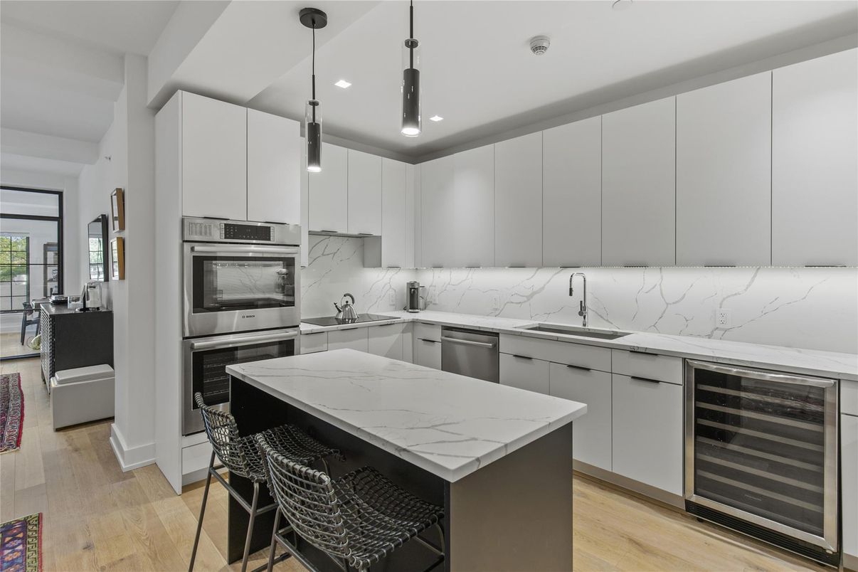 Interior, Kitchen, Marble Walls, Pendant Lights, Recessed Lighting, Stainless Steel Appliances, Wood Texture Flooring