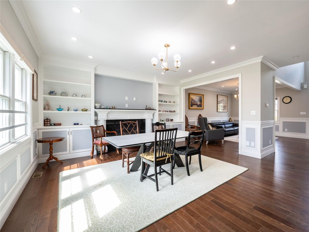 Chandelier, Dining room, Fireplace, Interior, Living room, Pendant Lights, Recessed Lighting, Wood Texture Flooring