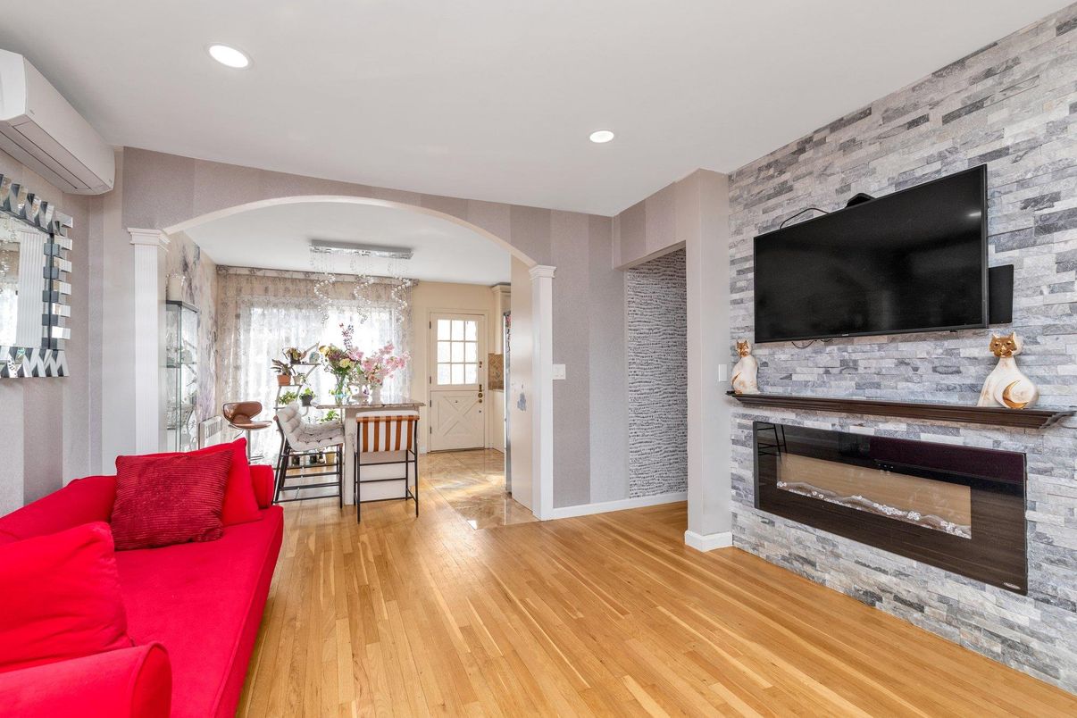 Dining room, Fireplace, Interior, Living room, Recessed Lighting, Stone Walls, Wood Texture Flooring