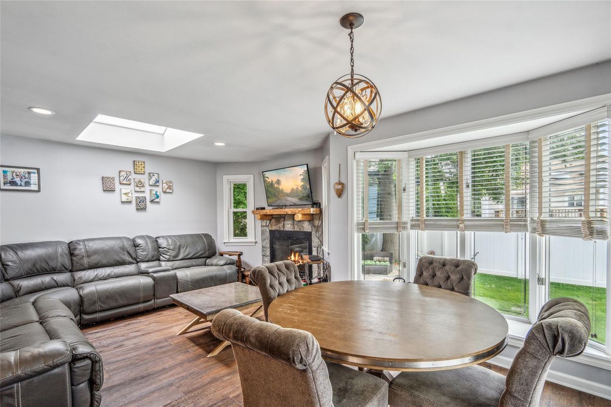 Dining room, Fireplace, Interior, Living room, Pendant Lights, Recessed Lighting, Wood Texture Flooring