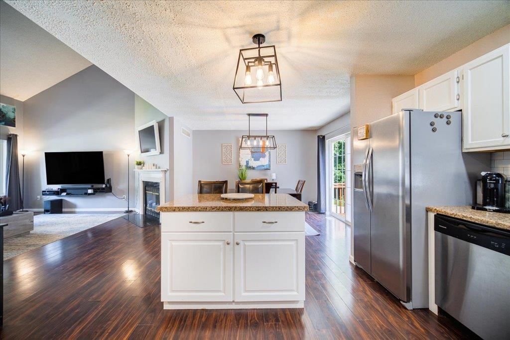 Dining room, Fireplace, Interior, Kitchen, Pendant Lights, Stainless Steel Appliances, Wood Texture Flooring