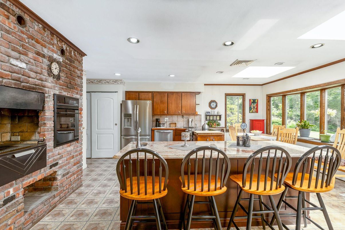 Fireplace, Interior, Kitchen, Recessed Lighting, Stainless Steel Appliances, Stone Walls