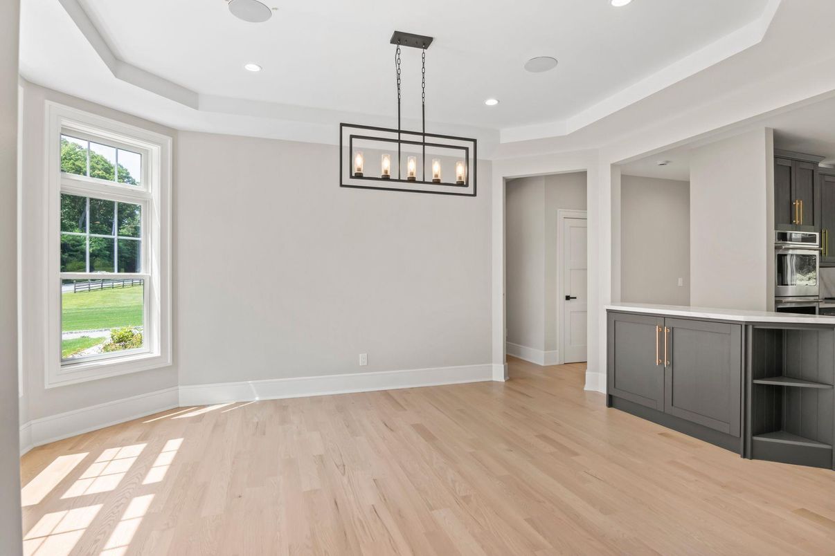 Empty room, Interior, Kitchen, Pendant Lights, Recessed Lighting, Stainless Steel Appliances, Wood Texture Flooring