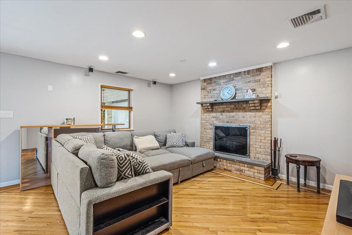 Fireplace, Interior, Living room, Recessed Lighting, Stone Walls, Wood Texture Flooring