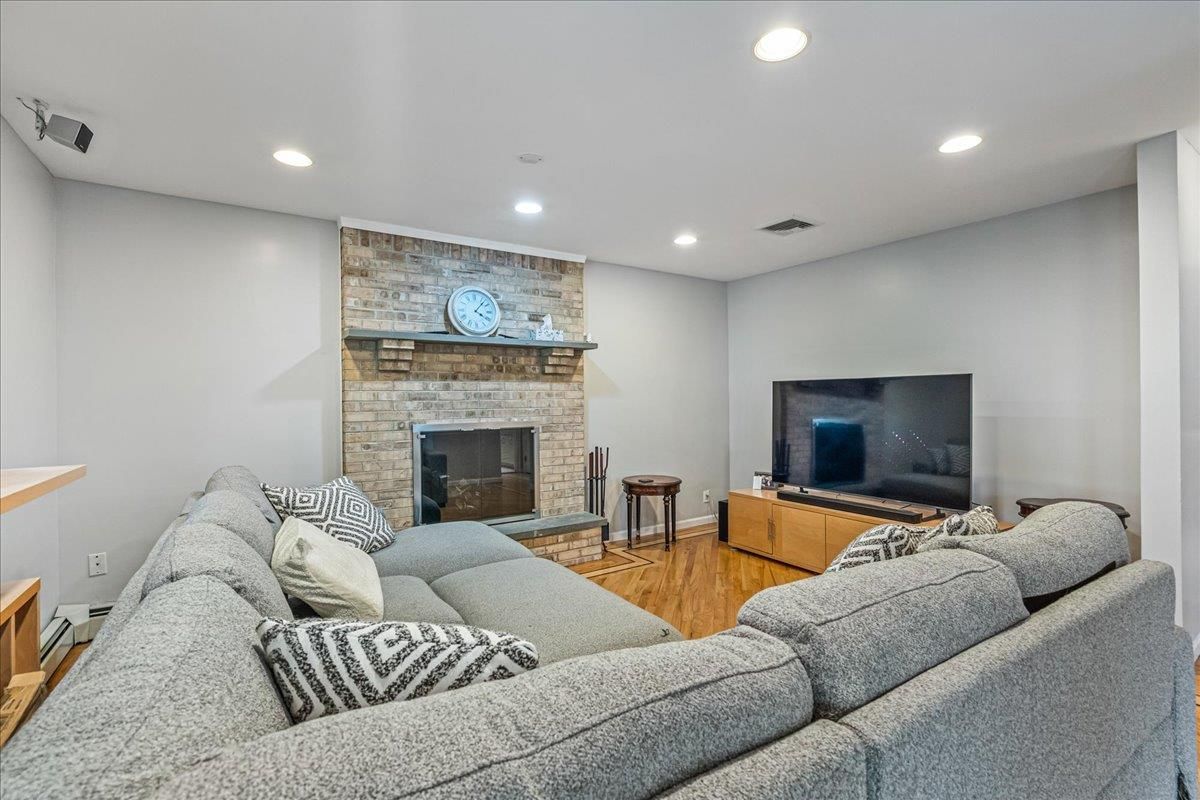 Fireplace, Interior, Living room, Recessed Lighting, Stone Walls, Wood Texture Flooring