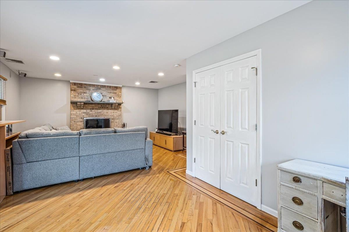 Fireplace, Interior, Living room, Recessed Lighting, Stone Walls, Wood Texture Flooring