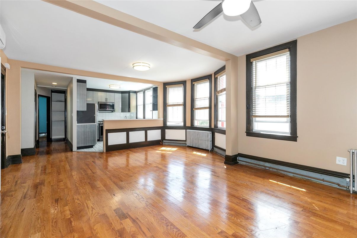 Empty room, Interior, Kitchen, Recessed Lighting, Stainless Steel Appliances, Wood Texture Flooring