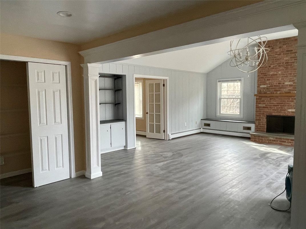 Chandelier, Empty room, Fireplace, Interior, Stone Walls, Wood Texture Flooring