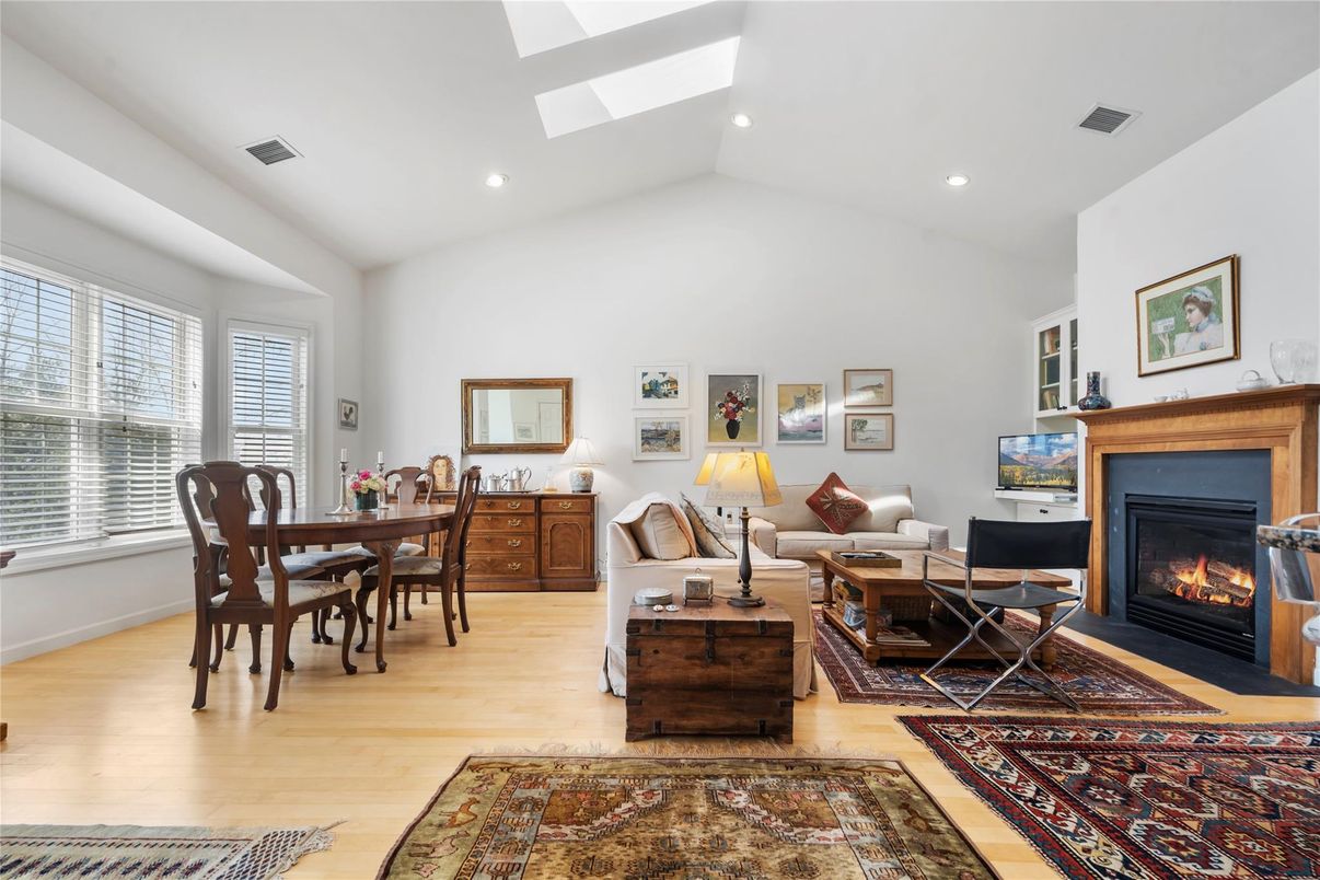 Dining room, Fireplace, Interior, Living room, Recessed Lighting, Wood Texture Flooring