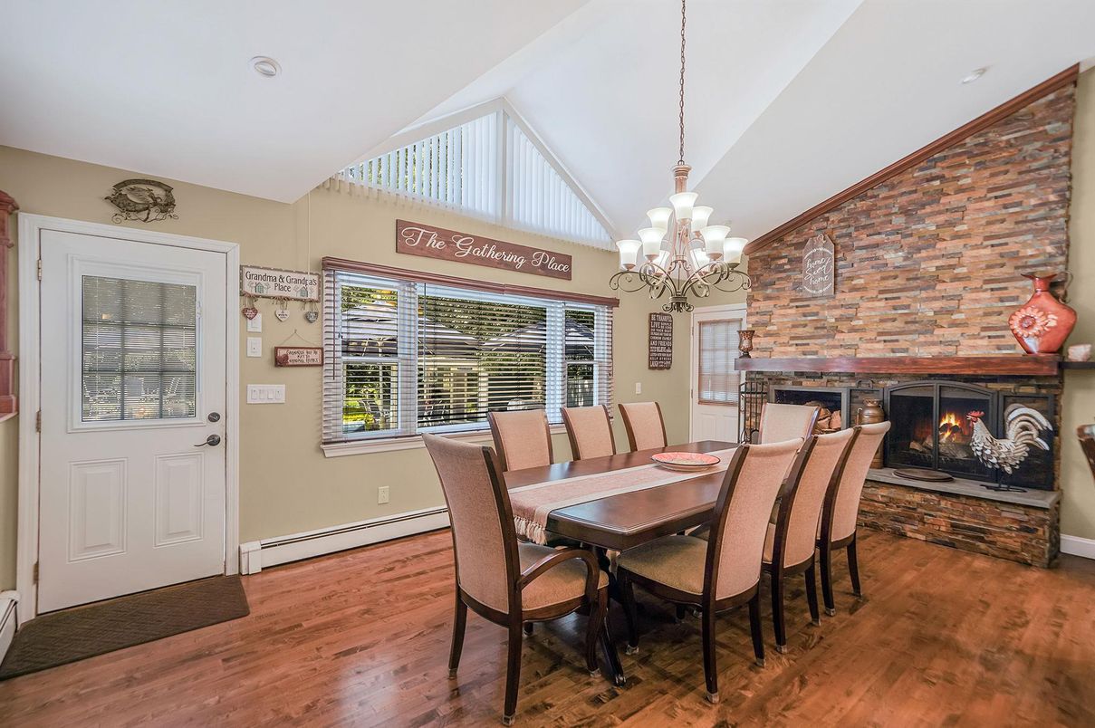 Chandelier, Dining room, Fireplace, Interior, Recessed Lighting, Stone Walls, Wood Texture Flooring