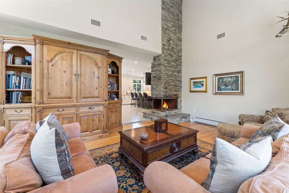 Fireplace, Interior, Living room, Recessed Lighting, Stone Walls, Wood Texture Flooring
