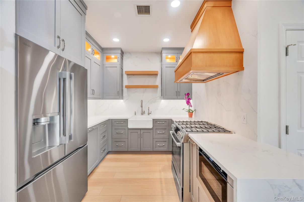 Interior, Kitchen, Marble Walls, Recessed Lighting, Stainless Steel Appliances, Wood Texture Flooring