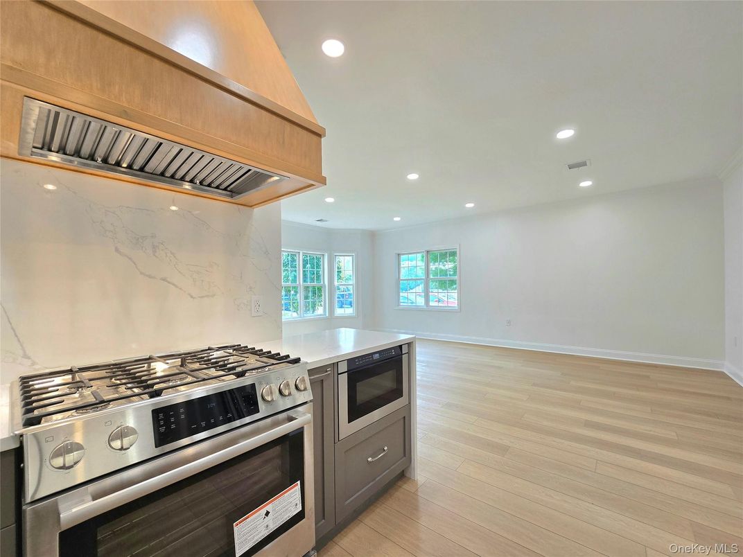 Interior, Kitchen, Marble Walls, Recessed Lighting, Stainless Steel Appliances, Wood Texture Flooring