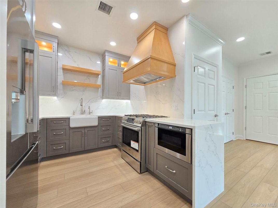 Interior, Kitchen, Marble Walls, Recessed Lighting, Stainless Steel Appliances, Wood Texture Flooring