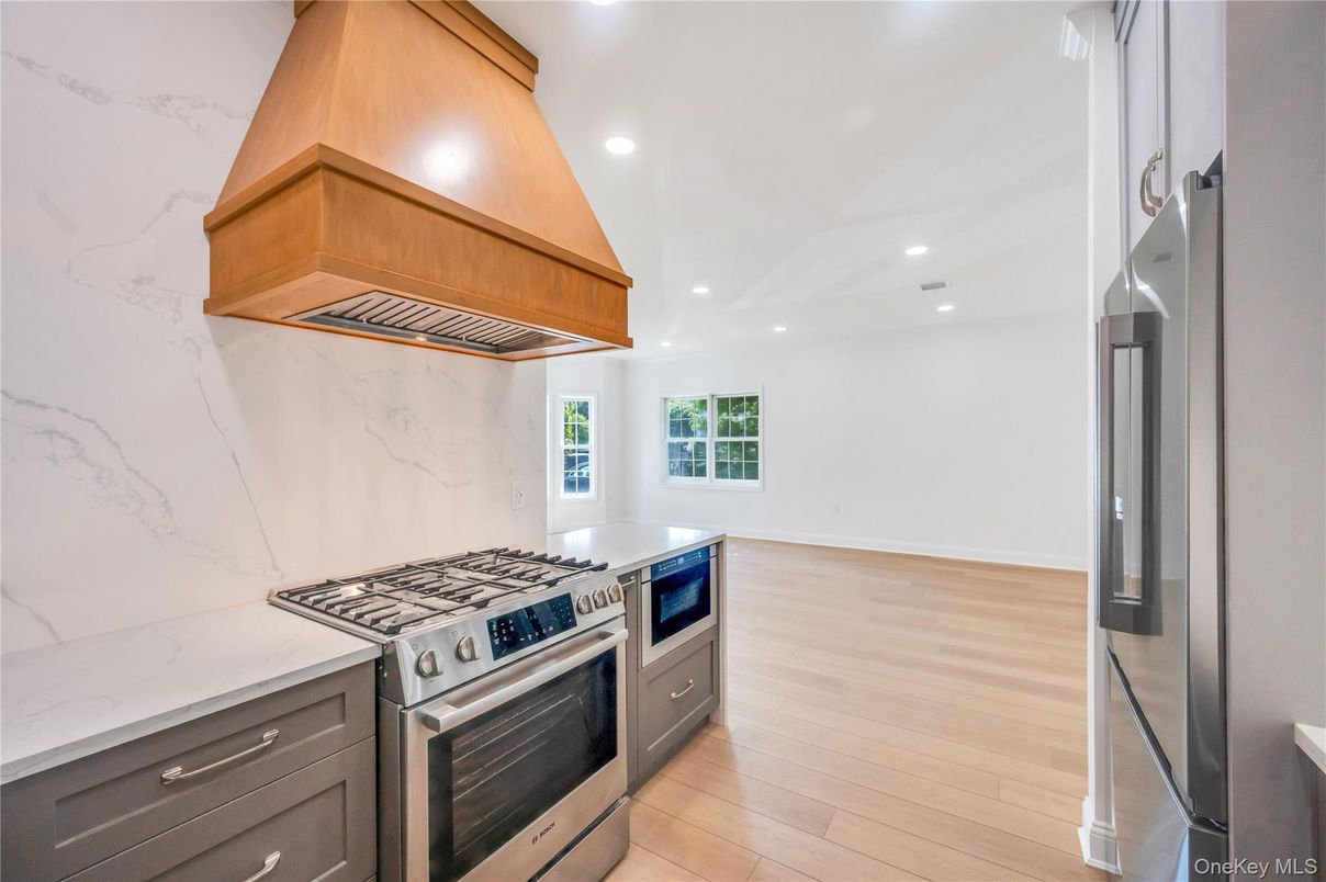 Interior, Kitchen, Marble Walls, Recessed Lighting, Stainless Steel Appliances, Wood Texture Flooring
