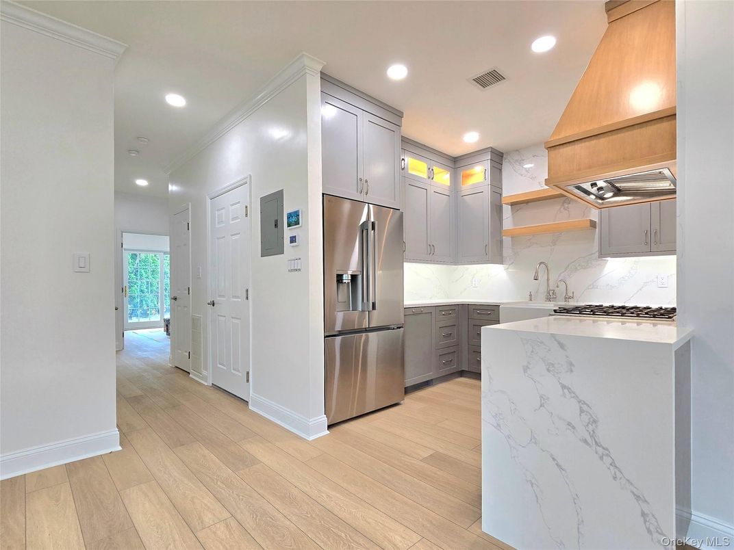 Interior, Kitchen, Marble Walls, Recessed Lighting, Stainless Steel Appliances, Wood Texture Flooring