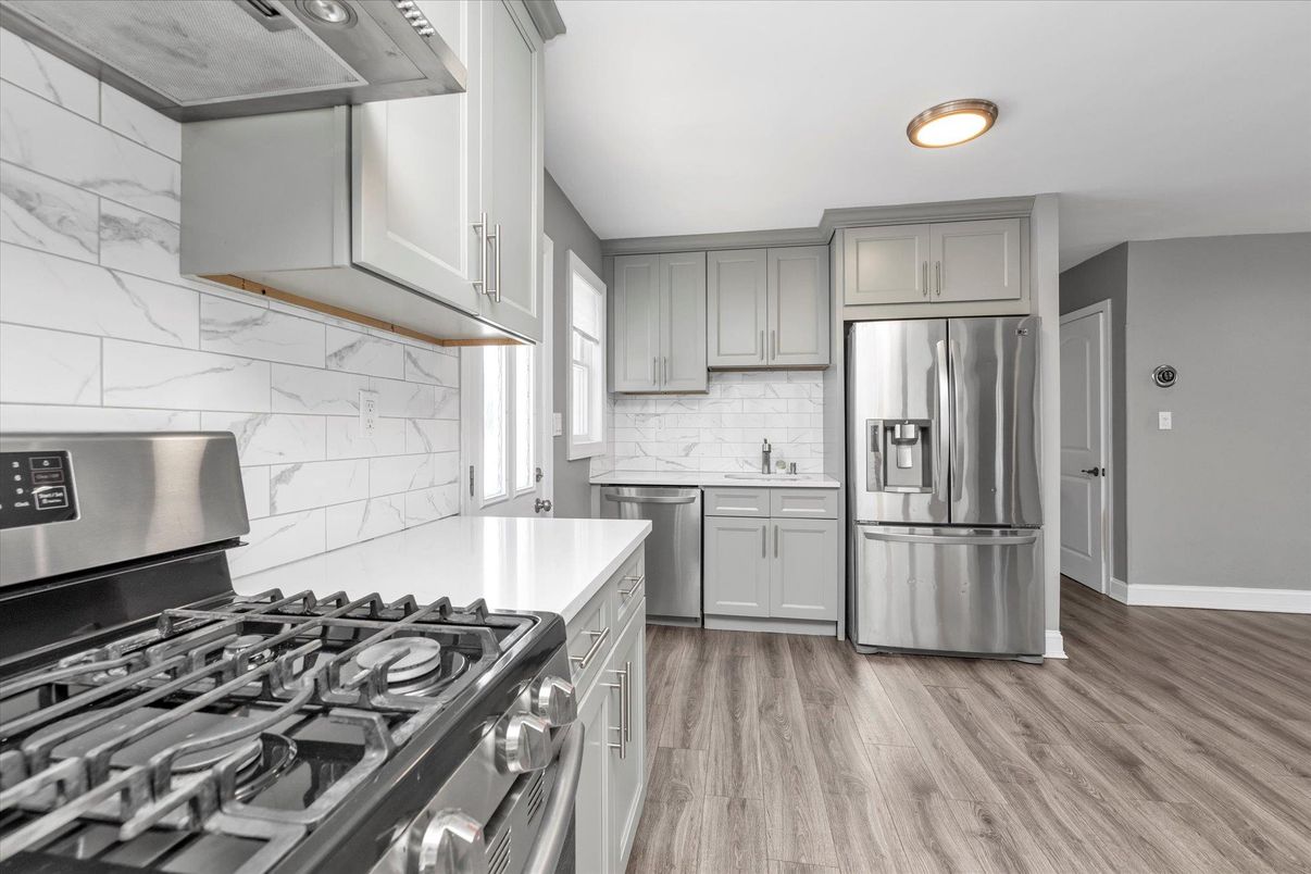 Interior, Kitchen, Marble Walls, Recessed Lighting, Stainless Steel Appliances, Wood Texture Flooring