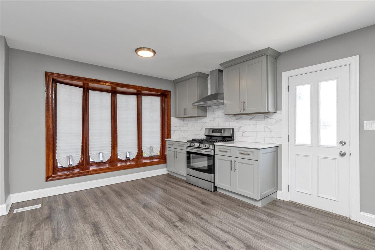 Interior, Kitchen, Marble Walls, Recessed Lighting, Stainless Steel Appliances, Wood Texture Flooring