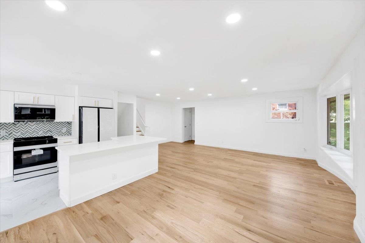 Empty room, Interior, Kitchen, Recessed Lighting, Stainless Steel Appliances, Wood Texture Flooring