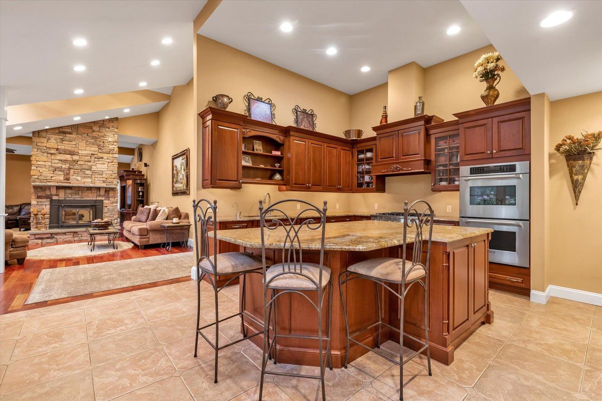 Fireplace, Interior, Kitchen, Living room, Recessed Lighting, Stainless Steel Appliances, Stone Walls