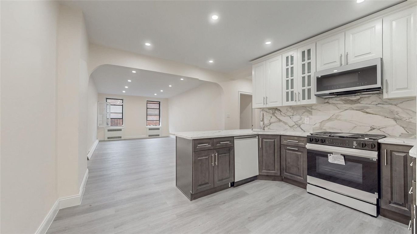 Interior, Kitchen, Marble Walls, Recessed Lighting, Stainless Steel Appliances, Wood Texture Flooring