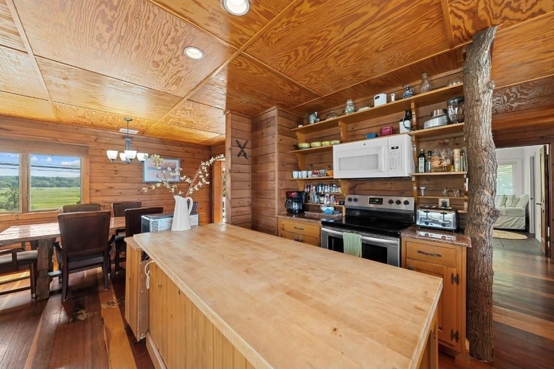 Chandelier, Dining room, Interior, Kitchen, Recessed Lighting, Stainless Steel Appliances, Wooden Ceilings, Wood Texture Flooring, Wooden Walls