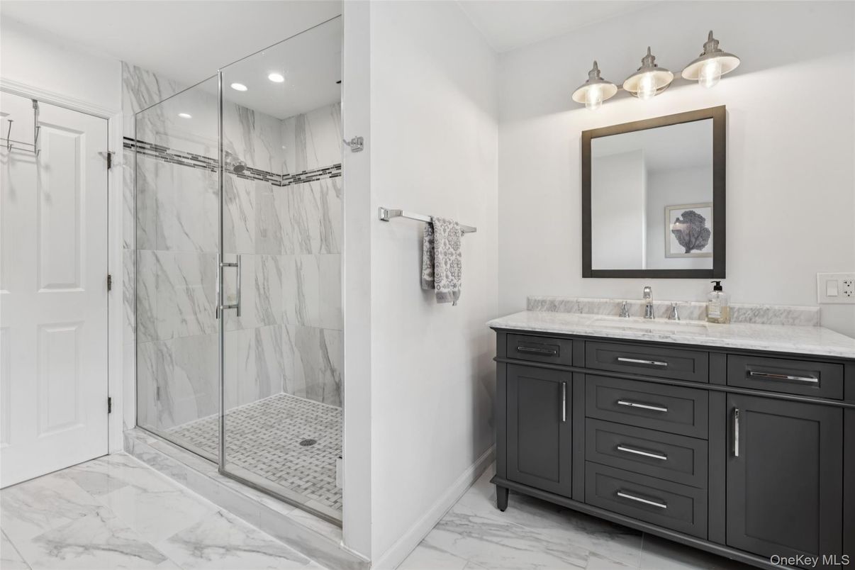 Bathroom, Dual Sink Vanities, Glass Shower, Interior, Marble, Marble Walls, Recessed Lighting