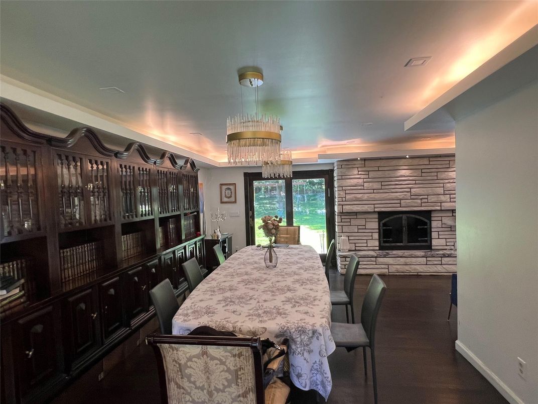 Chandelier, Dining room, Fireplace, Interior, Stone Walls, Wood Texture Flooring
