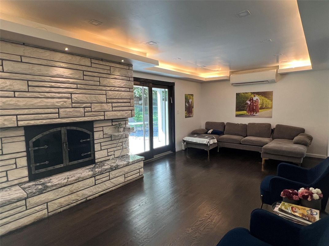 Fireplace, Interior, Living room, Recessed Lighting, Stone Walls, Wood Texture Flooring