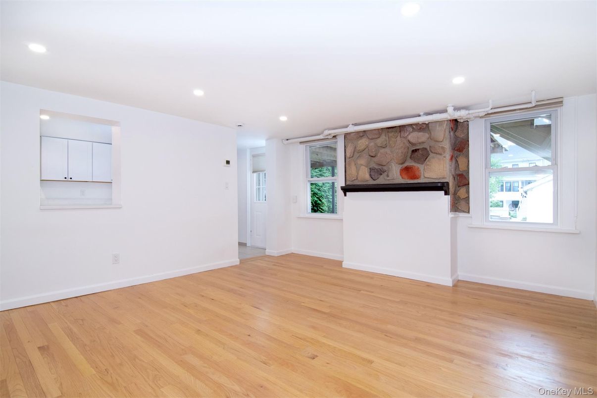 Empty room, Fireplace, Interior, Recessed Lighting, Stone Walls, Wood Texture Flooring