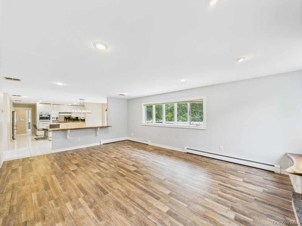 Empty room, Interior, Kitchen, Pendant Lights, Recessed Lighting, Stainless Steel Appliances, Wood Texture Flooring
