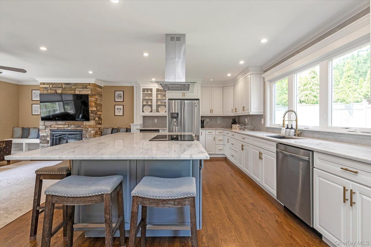 Fireplace, Interior, Kitchen, Recessed Lighting, Stainless Steel Appliances, Stone Walls, Wood Texture Flooring