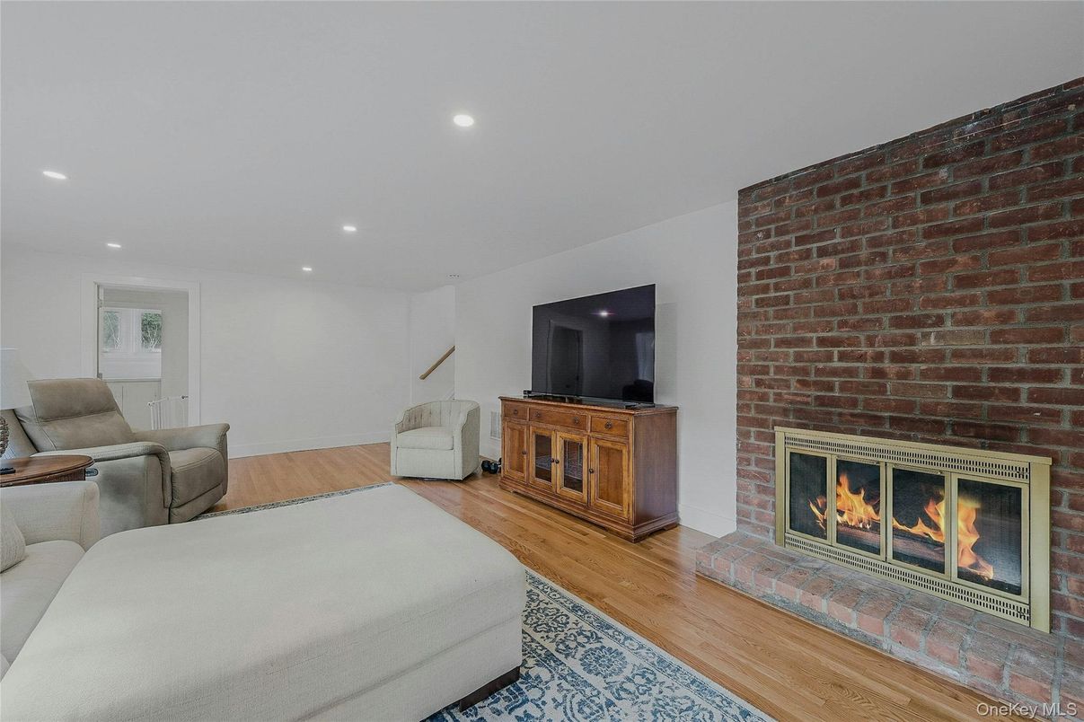 Fireplace, Interior, Living room, Recessed Lighting, Stone Walls, Wood Texture Flooring