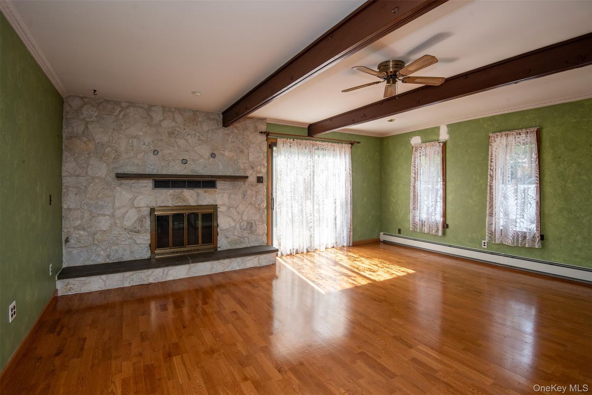 Empty room, Fireplace, Interior, Recessed Lighting, Stone Walls, Wooden Beams, Wood Texture Flooring