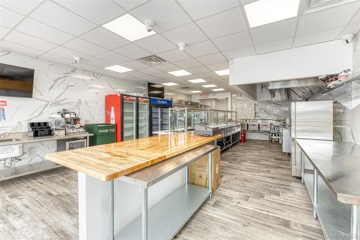 Interior, Kitchen, Marble Walls, Recessed Lighting, Stainless Steel Appliances, Wood Texture Flooring