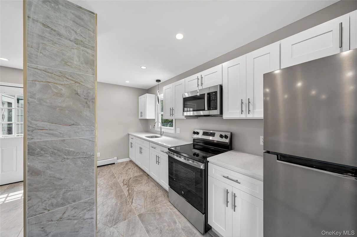 Interior, Kitchen, Marble Walls, Recessed Lighting, Stainless Steel Appliances