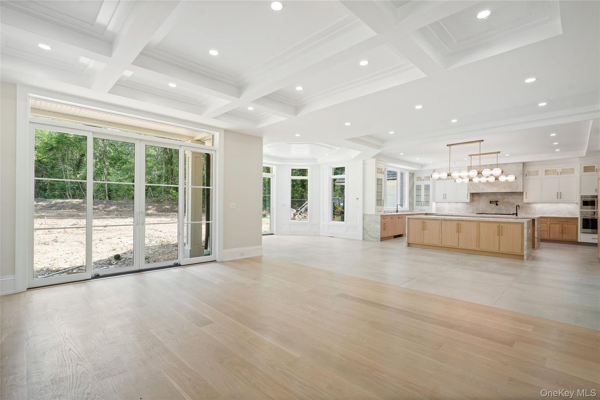 Empty room, Interior, Kitchen, Pendant Lights, Recessed Lighting, Stainless Steel Appliances, Wood Texture Flooring