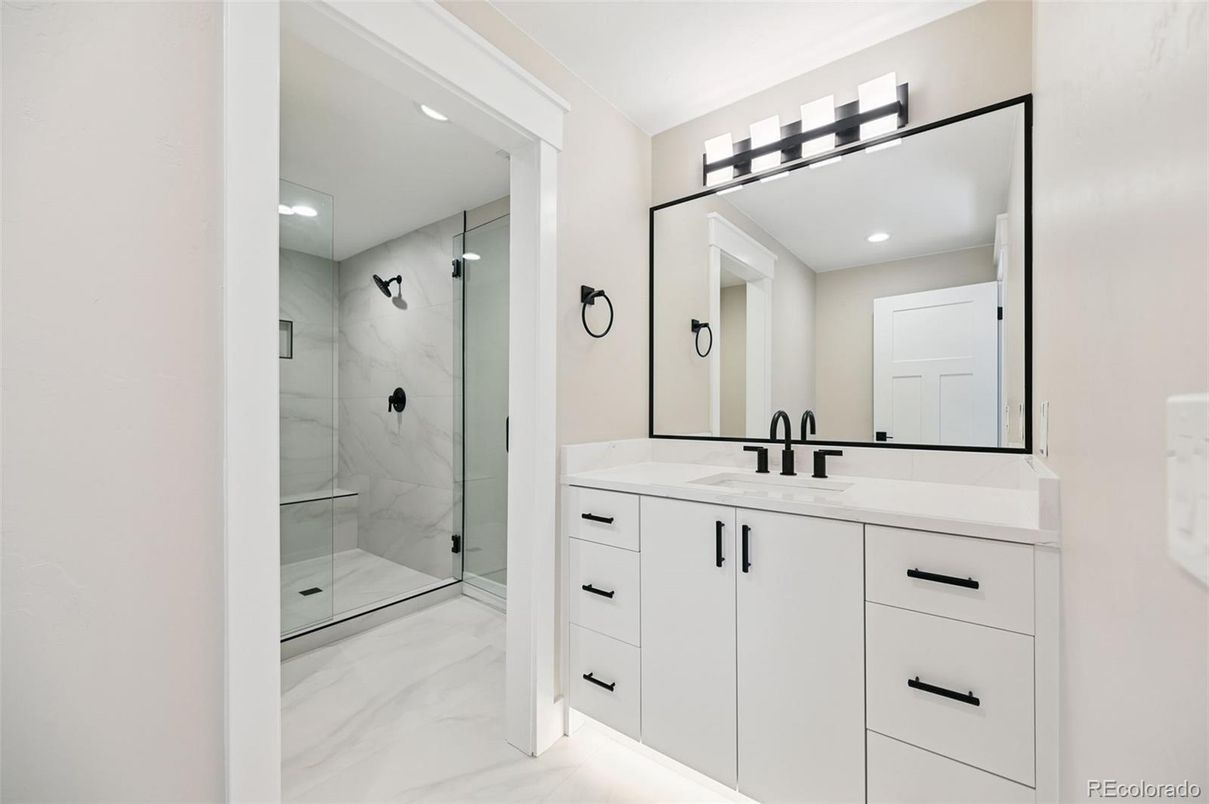 Bathroom, Dual Sink Vanities, Glass Shower, Interior, Marble, Marble Walls, Recessed Lighting