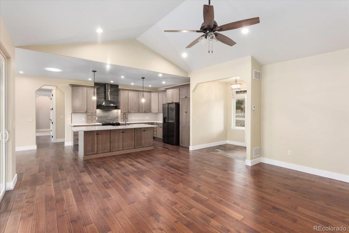 Empty room, Interior, Kitchen, Pendant Lights, Recessed Lighting, Stainless Steel Appliances, Wood Texture Flooring