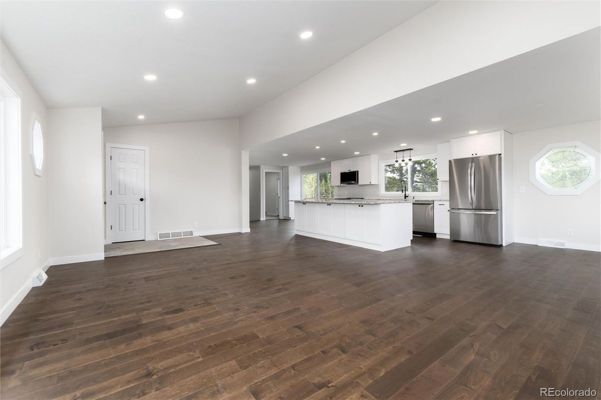 Empty room, Interior, Kitchen, Recessed Lighting, Stainless Steel Appliances, Wood Texture Flooring