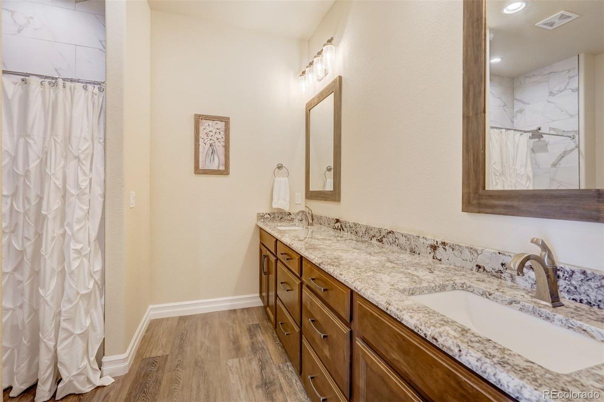 Bathroom, Dual Sink Vanities, Interior, Marble Walls, Recessed Lighting, Wood Texture Flooring