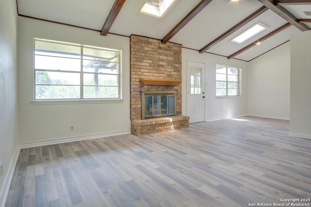 Empty room, Fireplace, Interior, Stone Walls, Wooden Beams, Wood Texture Flooring