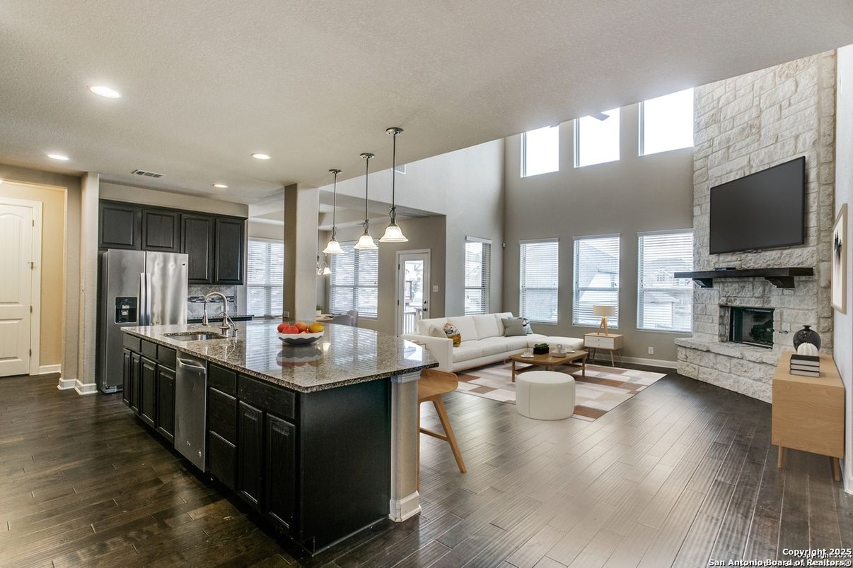 Fireplace, Interior, Kitchen, Living room, Pendant Lights, Recessed Lighting, Stainless Steel Appliances, Stone Walls, Wood Texture Flooring