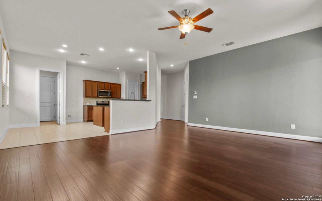 Empty room, Interior, Kitchen, Recessed Lighting, Stainless Steel Appliances, Wood Texture Flooring