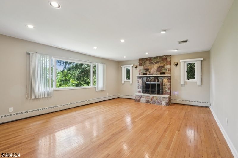 Empty room, Fireplace, Interior, Recessed Lighting, Stone Walls, Wood Texture Flooring