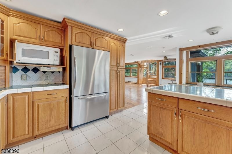 Interior, Kitchen, Recessed Lighting, Tile Countertops, Wood Texture Flooring