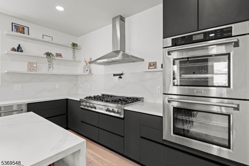 Interior, Kitchen, Marble Walls, Recessed Lighting, Stainless Steel Appliances, Wood Texture Flooring